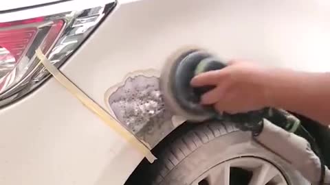 The mechanic repaired the broken paint on the car