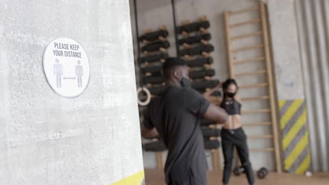 A Social Distancing Sign on a Wall at a Gym