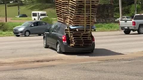 Tiny Car Transports Tower of Pallets