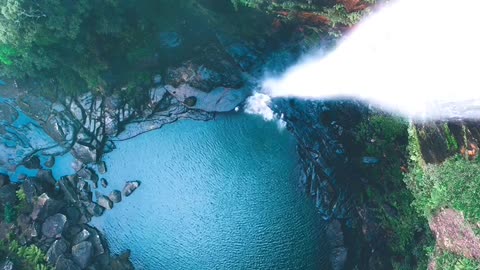 The bottom of a giant deep pit, with waterfalls cascading down