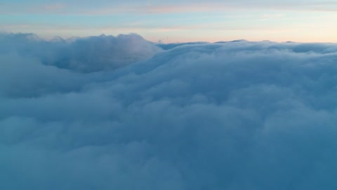 Flying over a thick layer of clouds in the sky