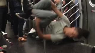 Guy grey dancing spinning subway pole