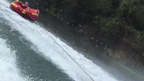 Person on tube wakeboarding flips over