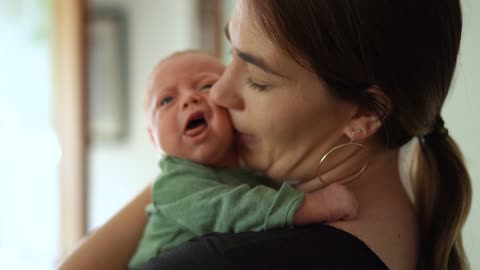 Mother Holding Baby In Arms