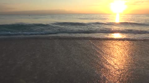 Beach waves and Rising Sun