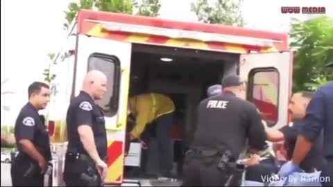 USA - Police officer punching a civilian taken away in an ambulance