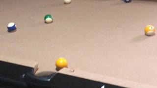 My five year old daughter playing pool