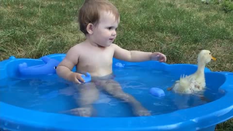 Cute Baby Playing With Duck in Water