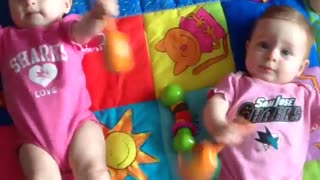 Twin babies shake mariachi rattles in unison
