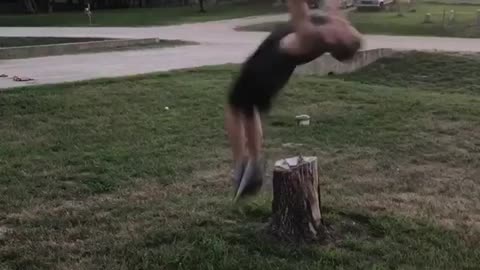 Guy backflips over tree stump, head hits stump