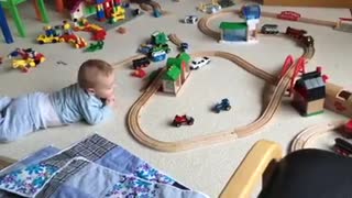 Cute baby watching his train move