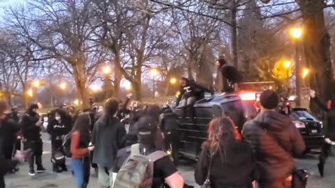 Black-clad insurgents in Portland flip over a family in an SUV.