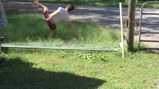 Guy jumps over gate it falls