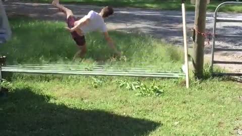 Guy jumps over gate it falls