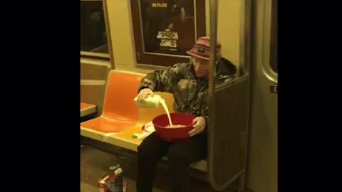 Man eats lucky charms in large red bowl