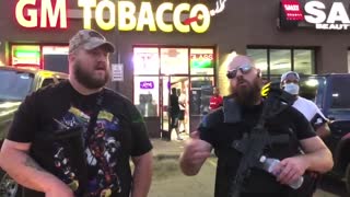 Fake news report crops footage of diverse armed Americans guarding businesses