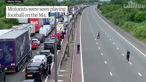 Drivers play football on motorway as fuel price protests bring traffic to a stan