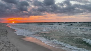 Orange red beach sunrise with cool waves