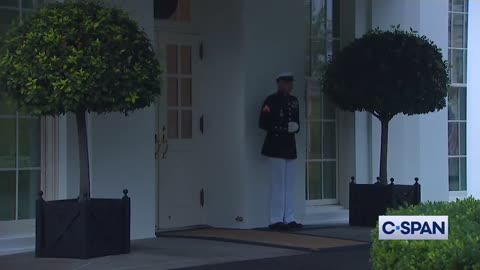 Lightning strikes outside White House as Marine Sentry stands his post.