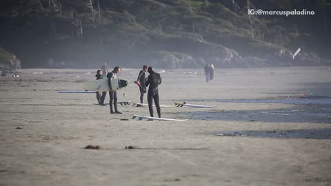 Wetsuit guy stretches and warms up before surfing