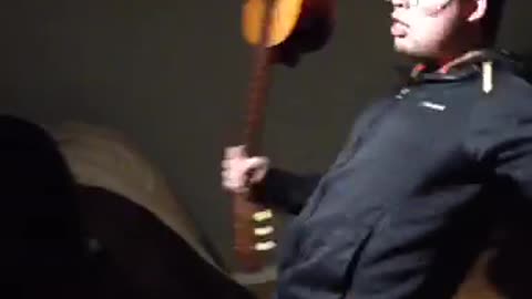 Man crushes guitar on head