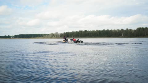 Motorboat and jet ski sailing on a lake