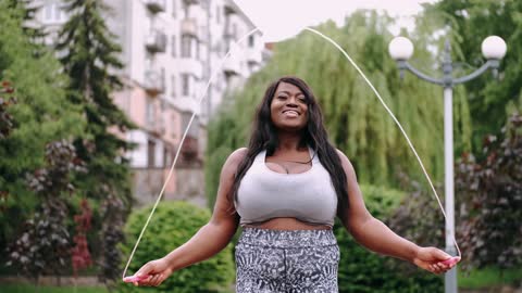 A Woman Exercising Using A Jumping Rope