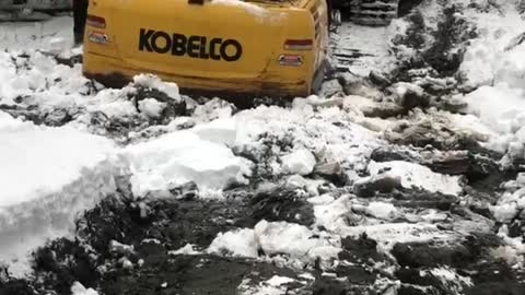 Excavator in deep rescuing a Groomer!