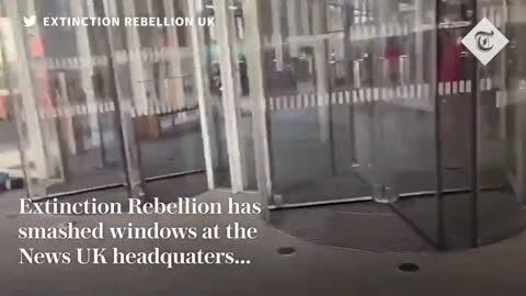 Extinction Rebellion smash windows at News UK offices