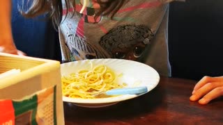 Daughter enjoying eating her fav spaghetti