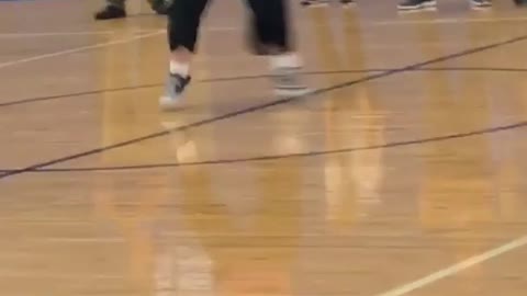 Girl in pink dances in basketball court