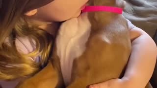 Little Girl Holds Her Best Puppy Pal