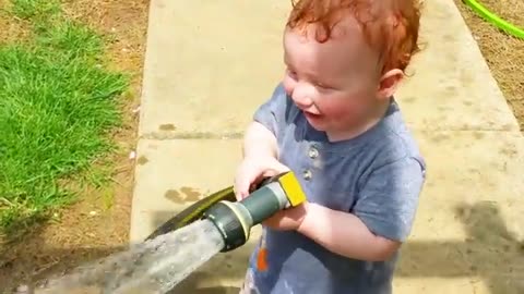 Funny babies playing with water