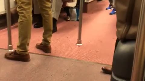 Black helmet man has razor scooter on subway