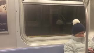 Guy gets out of train in the middle of the tunnel and walks alongside the train as it starts moving slowly
