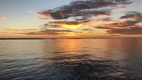 "Maldivian Magic: A Spellbinding Sunset on the Glassy Sea"