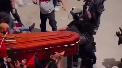 Israeli troops kicking the shit out of an islamist coffin at a funeral