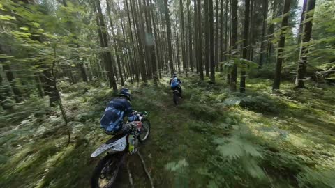 Areial Footage of Two Motorcyclists in the Woods