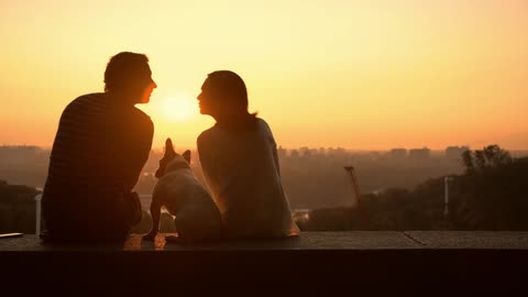 A couple in love watching a romantic sunset
