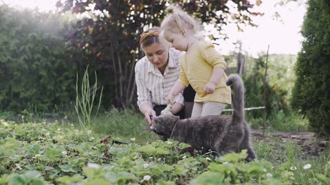 Woman And Her Child Cultivating The Soil (With Cat)