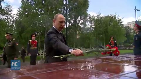 Putin braves rain to honor WWII victims