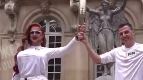 A drag queen carries the Olympic Flame in Paris