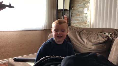 Dad gives his toddler a mohawk using a Dyson vacuum.