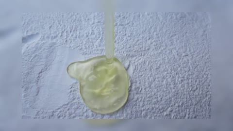 Slow Motion Of An Egg Yolk Falling On A Pile Of Flour