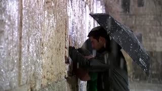 Snow covers Jerusalem as a storm hits the region