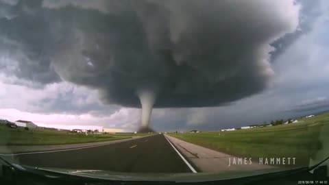 Storm chasing dashcam: Tornado crossing the highway! Laramie, Wyoming