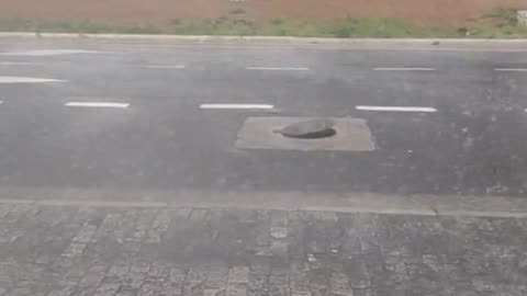 Water Pressure From Storm Creates a Bouncing Manhole Cover