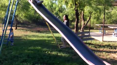 Grandma takes slide too fast, totally wipes out
