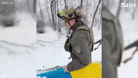 their flag near the Russian border despite the risk of shelling