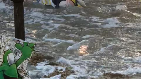 Napping Child is Woken Up By Waves